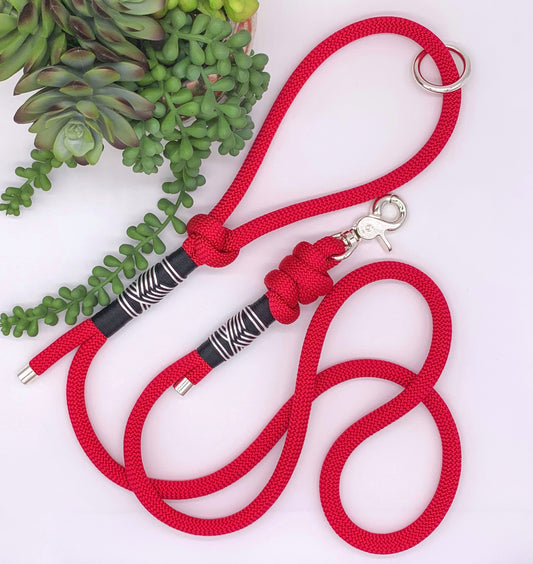 Red PPM rope leash with black and white accent thread in a chevron pattern and silver hardware. 