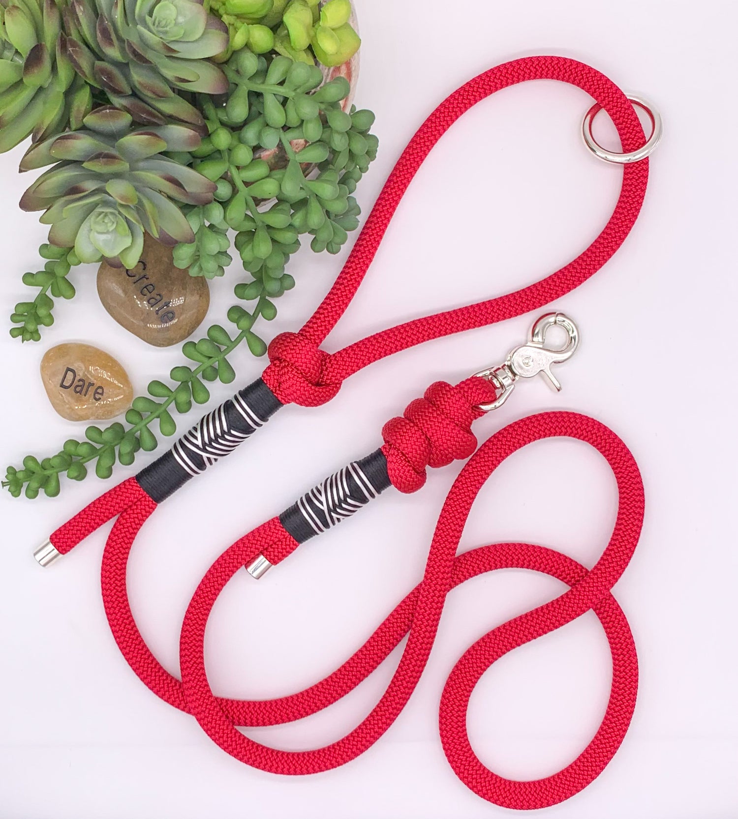 Red PPM rope leash with black and white accent thread in a chevron pattern and silver hardware. 